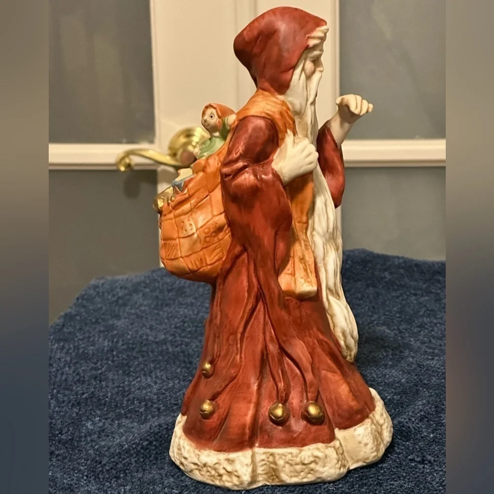 Incredible porcelain Santa carries his pack& wears a brownish robe.